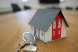 white-and-red-wooden-house-miniature-on-brown-table.jpg white and red wooden house miniature on brown table